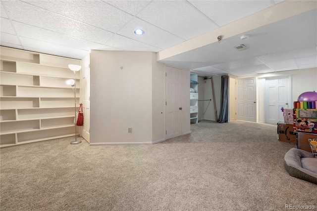 basement with carpet flooring and a drop ceiling