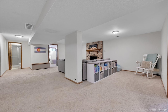 living area with carpet floors, baseboards, and a brick fireplace