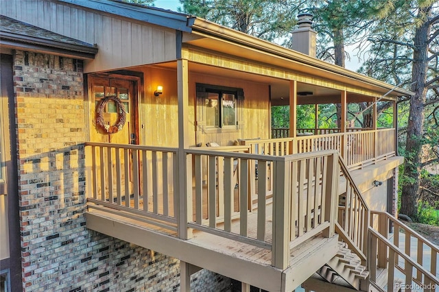 wooden deck with stairway and an attached garage