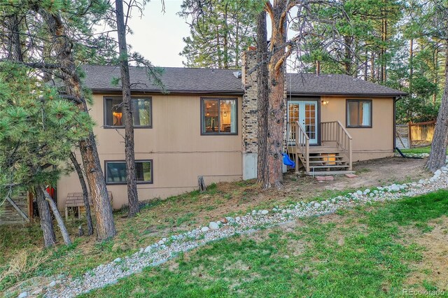 view of front of house featuring fence and french doors