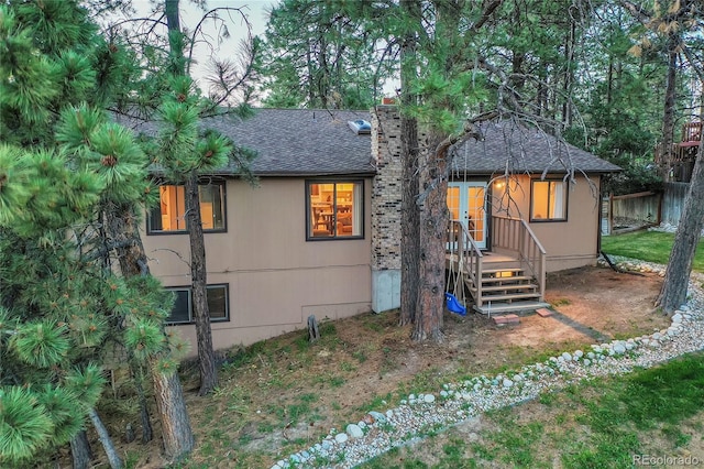 view of front of property featuring roof with shingles