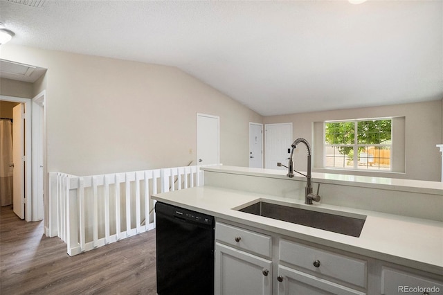 8401 Sandreed Cir, Parker, CO 80134 - kitchen with black dishwasher, wood finished floors, light countertops, lofted ceiling, and white cabinetry