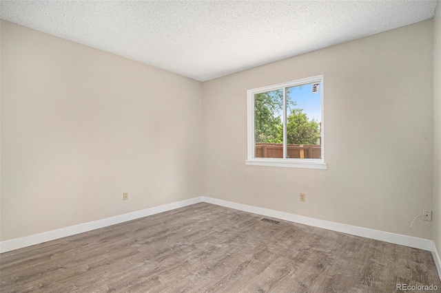 8401 Sandreed Cir, Parker, CO 80134 - spare room featuring wood finished floors and a textured ceiling