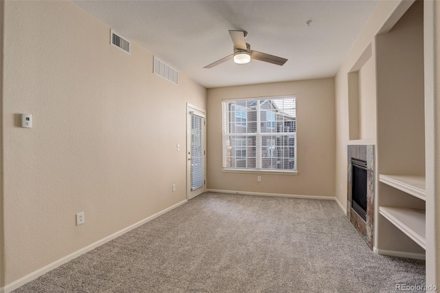 unfurnished living room featuring ceiling fan and light carpet