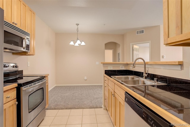 kitchen featuring sink, hanging light fixtures, stainless steel appliances, light brown cabinets, and light tile patterned floors