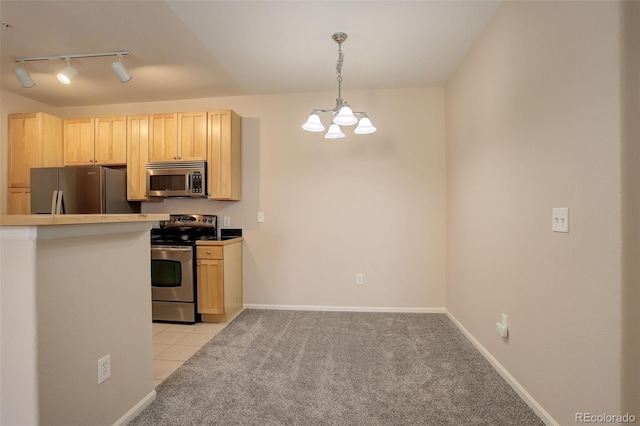 kitchen with pendant lighting, track lighting, stainless steel appliances, light brown cabinetry, and light colored carpet