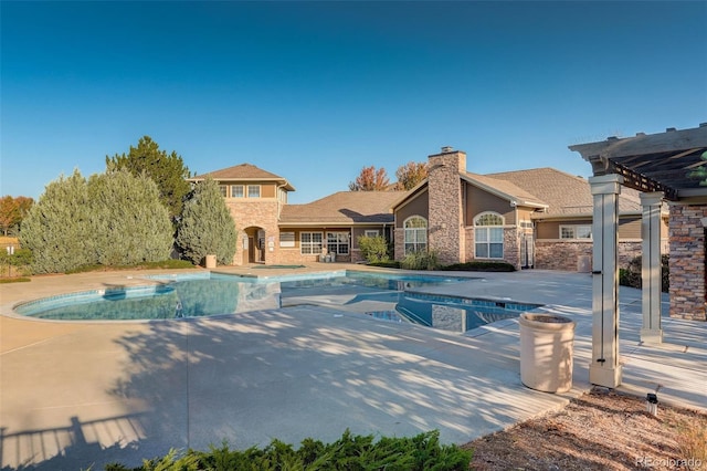 view of swimming pool featuring a patio, an in ground hot tub, and a pergola