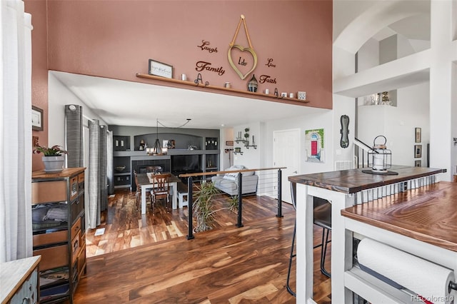 16863 Trail View Cir, Parker, CO 80134 - kitchen featuring a towering ceiling, wood finished floors, and a chandelier