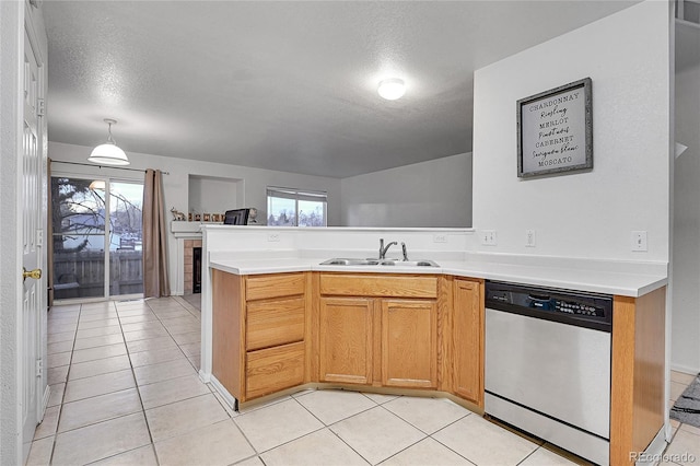 kitchen with a textured ceiling, dishwasher, plenty of natural light, and sink