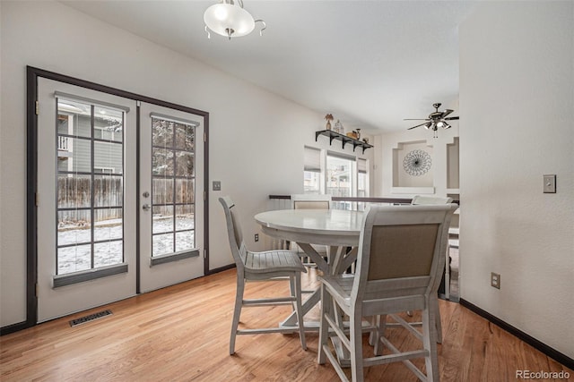 dining room with ceiling fan, light hardwood / wood-style floors, and french doors