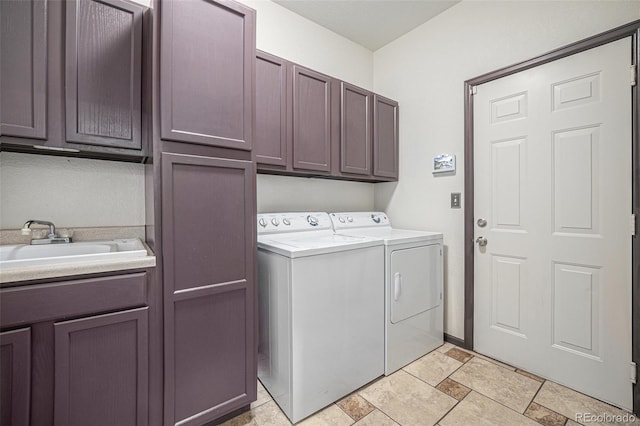 washroom featuring washer and dryer, cabinets, and sink