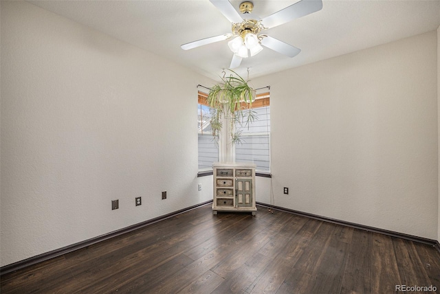 spare room featuring ceiling fan and dark hardwood / wood-style flooring