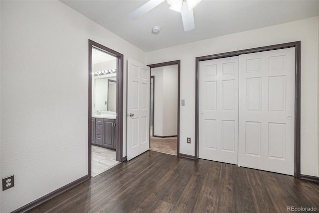 unfurnished bedroom with ceiling fan, connected bathroom, dark hardwood / wood-style floors, and a closet