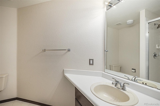 bathroom with vanity, an enclosed shower, and toilet