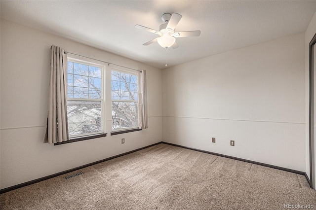 empty room with ceiling fan and carpet floors