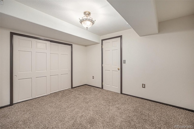 unfurnished bedroom featuring carpet flooring and a closet