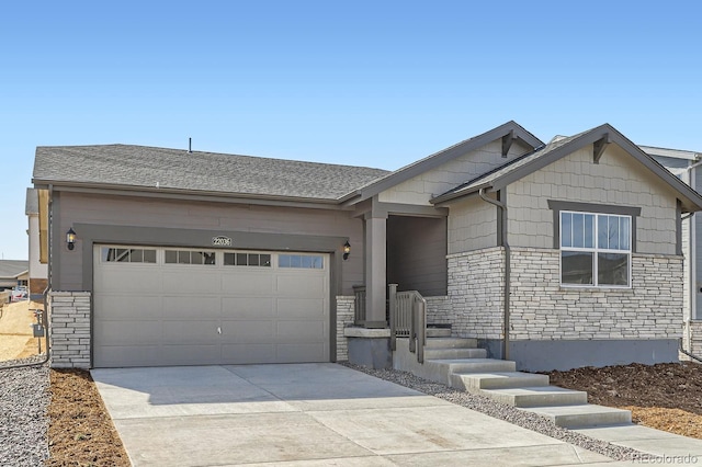 single story home with a garage, stone siding, driveway, and roof with shingles