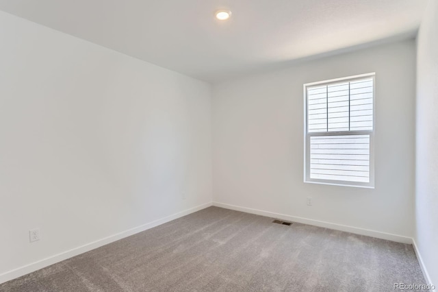 empty room with recessed lighting, visible vents, baseboards, and carpet floors