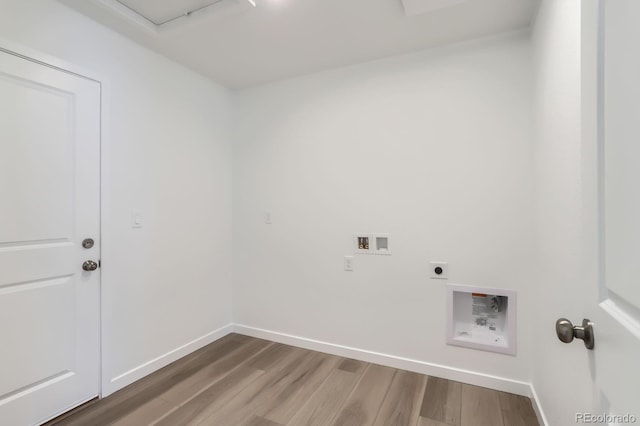 clothes washing area featuring electric dryer hookup, wood finished floors, baseboards, hookup for a washing machine, and laundry area