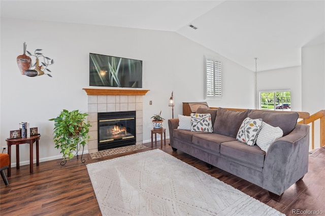 living room with lofted ceiling, wood finished floors, a fireplace, and baseboards