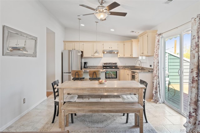 kitchen featuring stainless steel appliances, cream cabinets, ceiling fan, lofted ceiling, and a sink