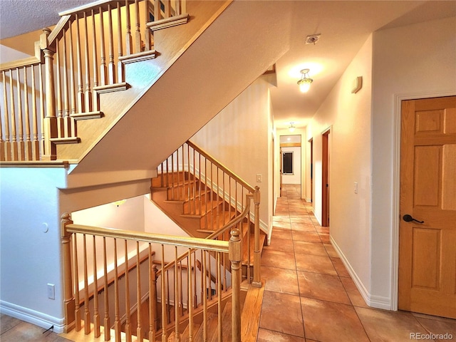 staircase with tile patterned flooring