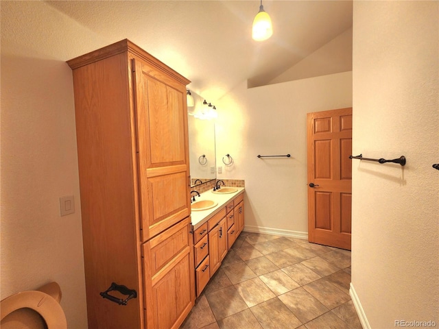 bathroom featuring vanity and vaulted ceiling