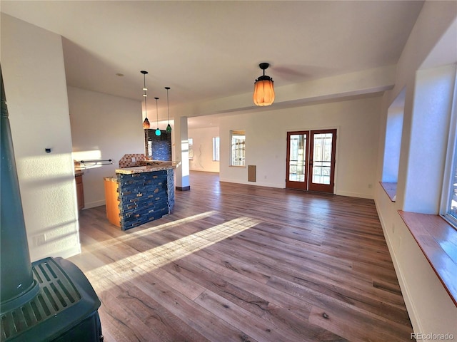 unfurnished living room with dark wood-type flooring and french doors