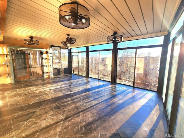 unfurnished sunroom featuring wood ceiling and ceiling fan