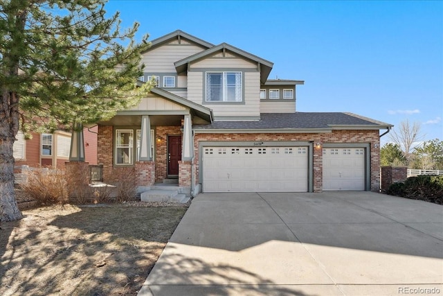 craftsman house with brick siding, driveway, a shingled roof, and a garage