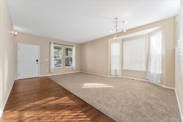 interior space featuring wood finished floors, baseboards, and carpet floors