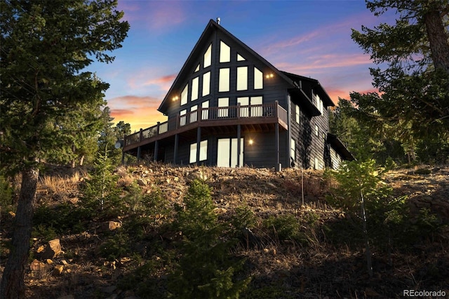538 Sawmill Creek Rd, Evergreen, CO 80439 - back of house at dusk featuring a deck