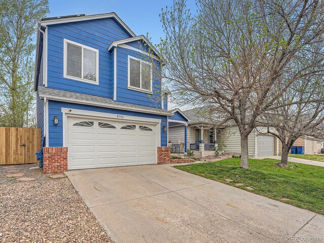 view of front of house featuring a garage, brick siding, and driveway