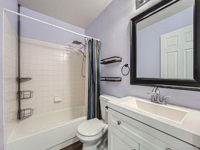 bathroom featuring a textured wall, toilet, shower / bath combo with shower curtain, and vanity