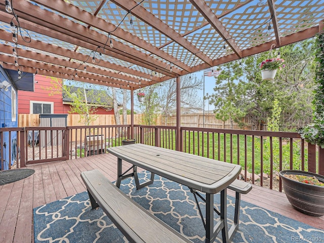 wooden terrace featuring fence, a pergola, and outdoor dining area