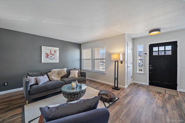 living room featuring a textured ceiling and dark hardwood / wood-style flooring