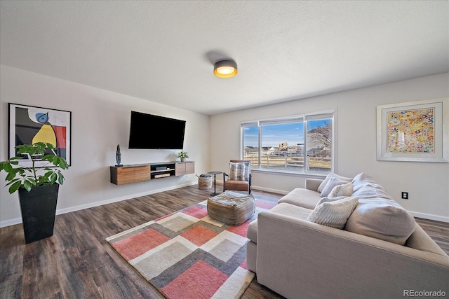 living room with dark hardwood / wood-style floors and a textured ceiling