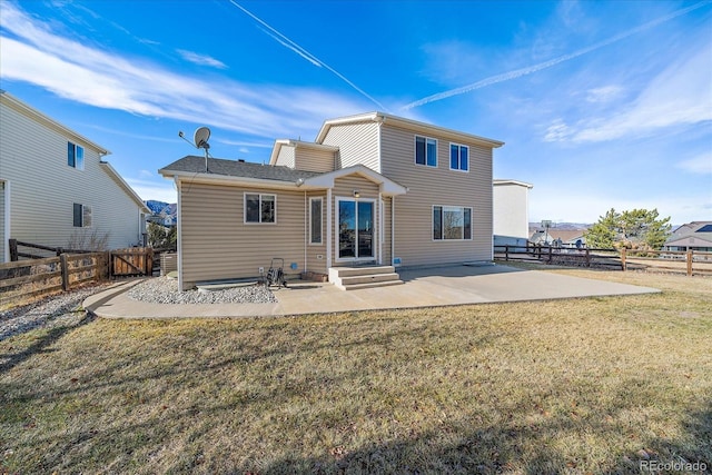 rear view of house with a yard and a patio