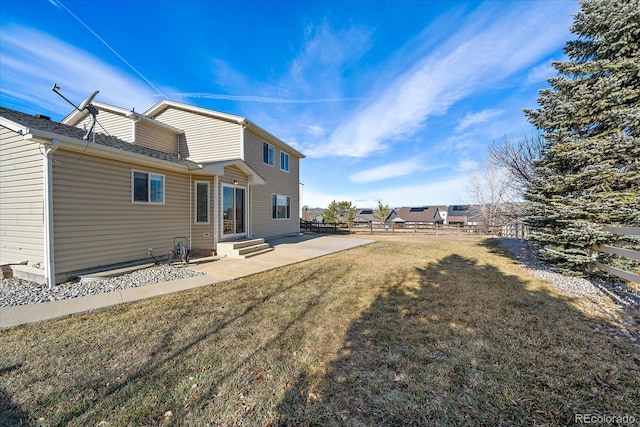 rear view of house with a lawn and a patio area