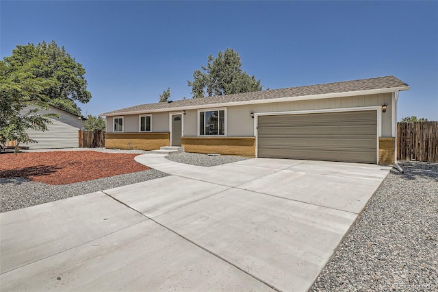 16273 E Brown Pl, Aurora, CO 80013 - ranch-style house featuring brick siding, an attached garage, and driveway
