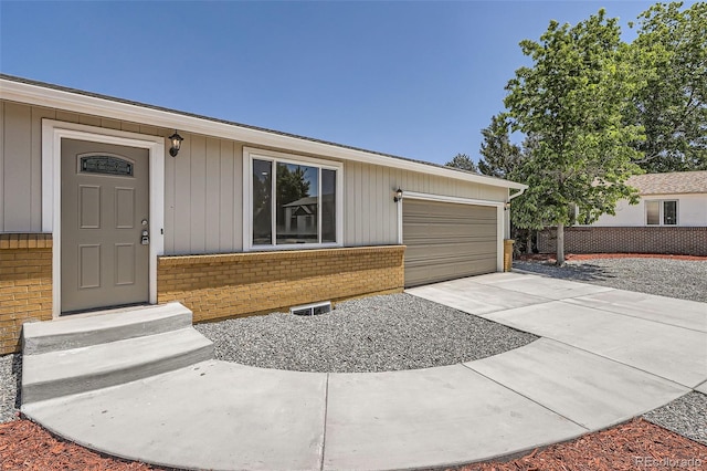 16273 E Brown Pl, Aurora, CO 80013 - view of front of home featuring brick siding, a garage, and driveway