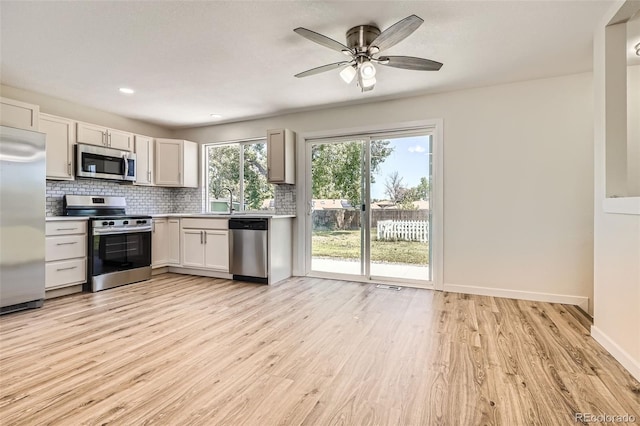 16273 E Brown Pl, Aurora, CO 80013 - kitchen with stainless steel appliances, tasteful backsplash, light wood-type flooring, light countertops, and recessed lighting