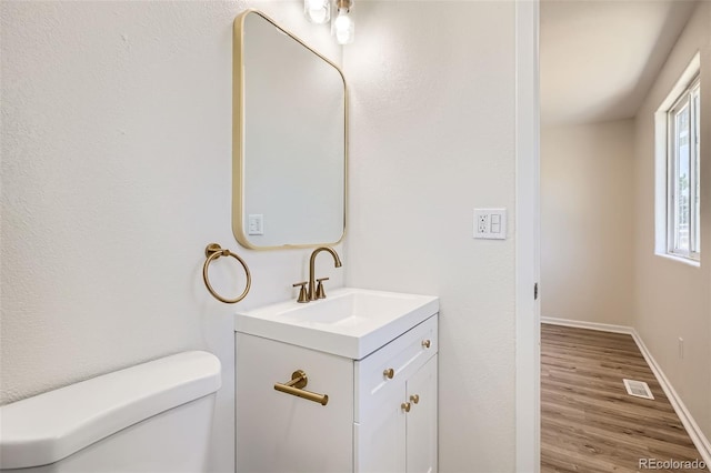 16273 E Brown Pl, Aurora, CO 80013 - half bathroom featuring vanity and wood finished floors