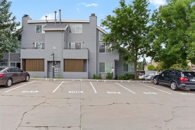 view of building exterior with uncovered parking