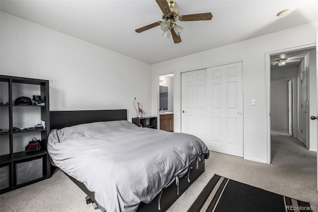 carpeted bedroom featuring baseboards, connected bathroom, and ceiling fan