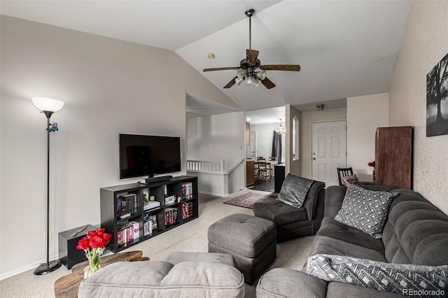 living room featuring a ceiling fan, carpet, and vaulted ceiling