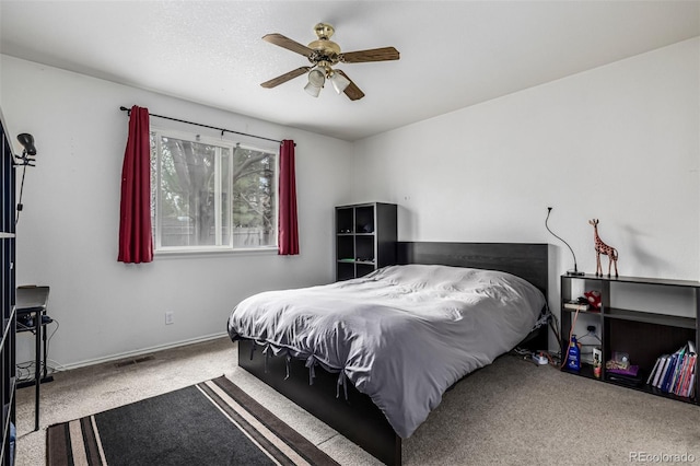 bedroom featuring baseboards, a ceiling fan, visible vents, and carpet