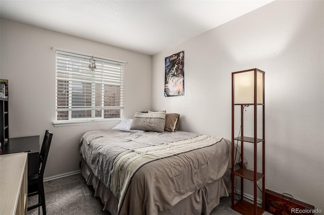 carpeted bedroom featuring baseboards