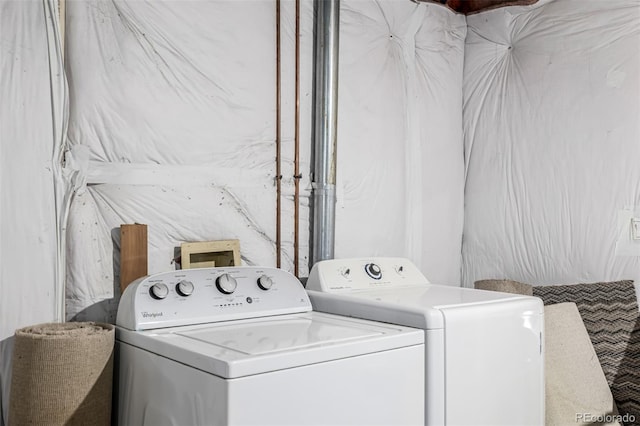 washroom with washer and clothes dryer and laundry area