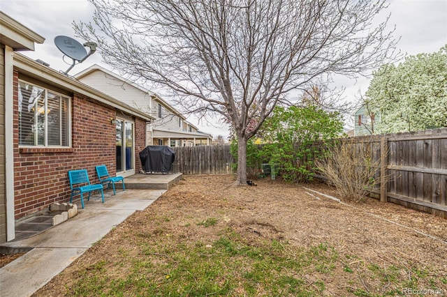 view of yard featuring a patio area and a fenced backyard